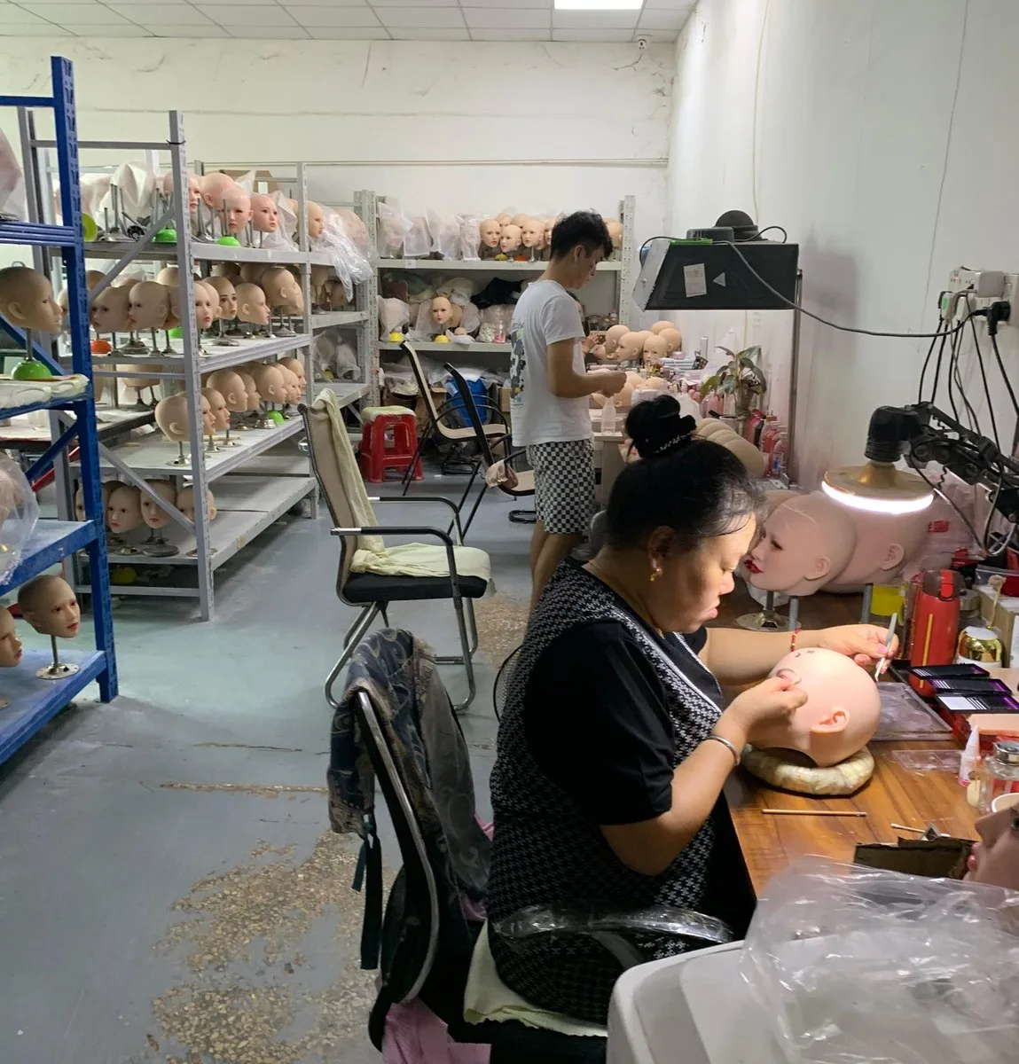 Doll bodies hanging to cure inside the Qianyou workshop