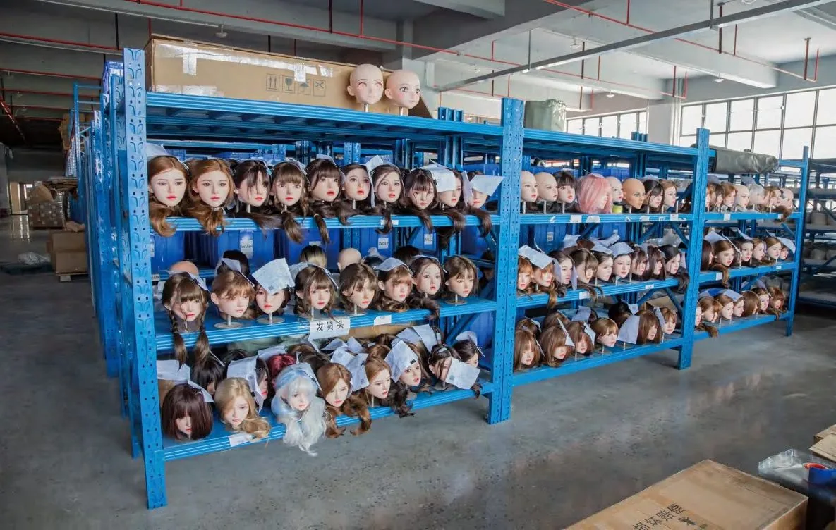 Doll heads stored on racks at the MZRAIDOLL factory